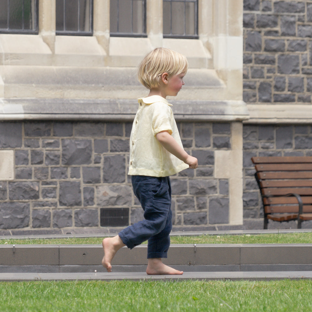 Boy walking around wearing organic clothing made by Twee & Co