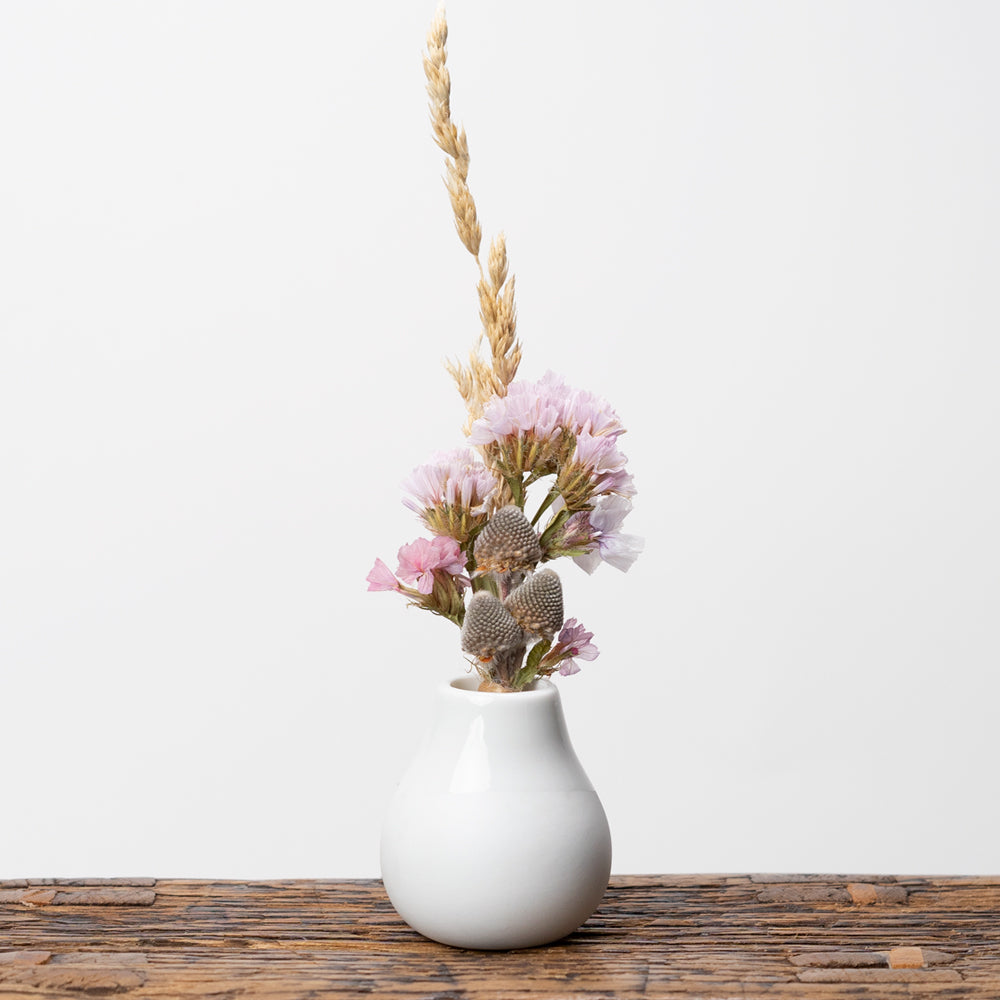 Light pink dried flowers arranged and displayed in vase by Twee & Co