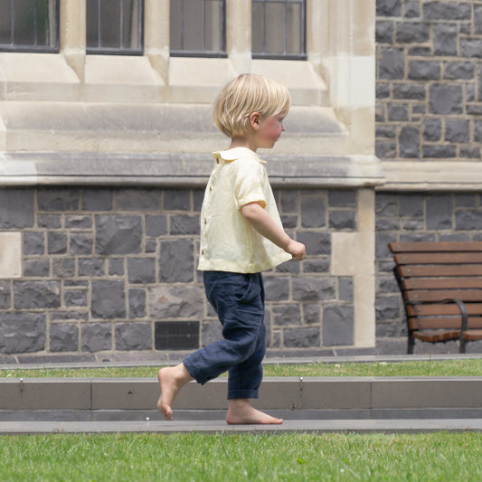 Boy walking around wearing organic clothing made by Twee & Co
