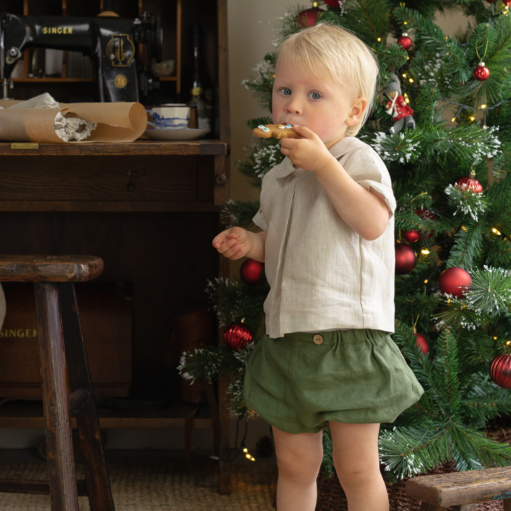 Boy wearing organic bloomers, in forest green — made by Twee & Co
