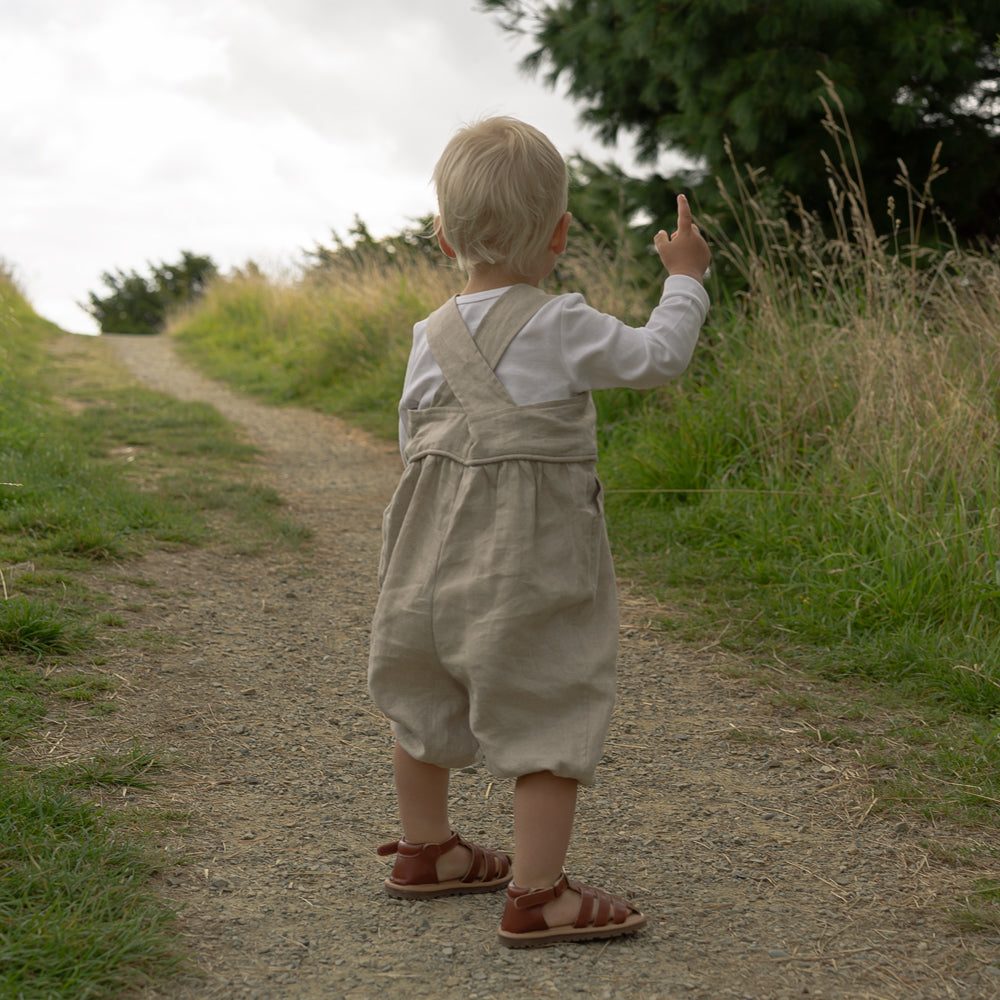 Little baby boy wearing Linen overalls made in New Zealand NZ by Twee & Co Organic Boutique