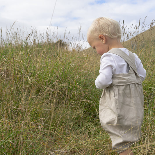 Little baby boy wearing Linen overalls made in New Zealand NZ by Twee & Co Organic Boutique