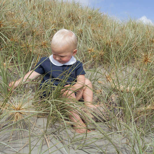 Young boy wearing Little Noah, organic cotton navy shirt with white Peter Pan collar — by Twee & Co