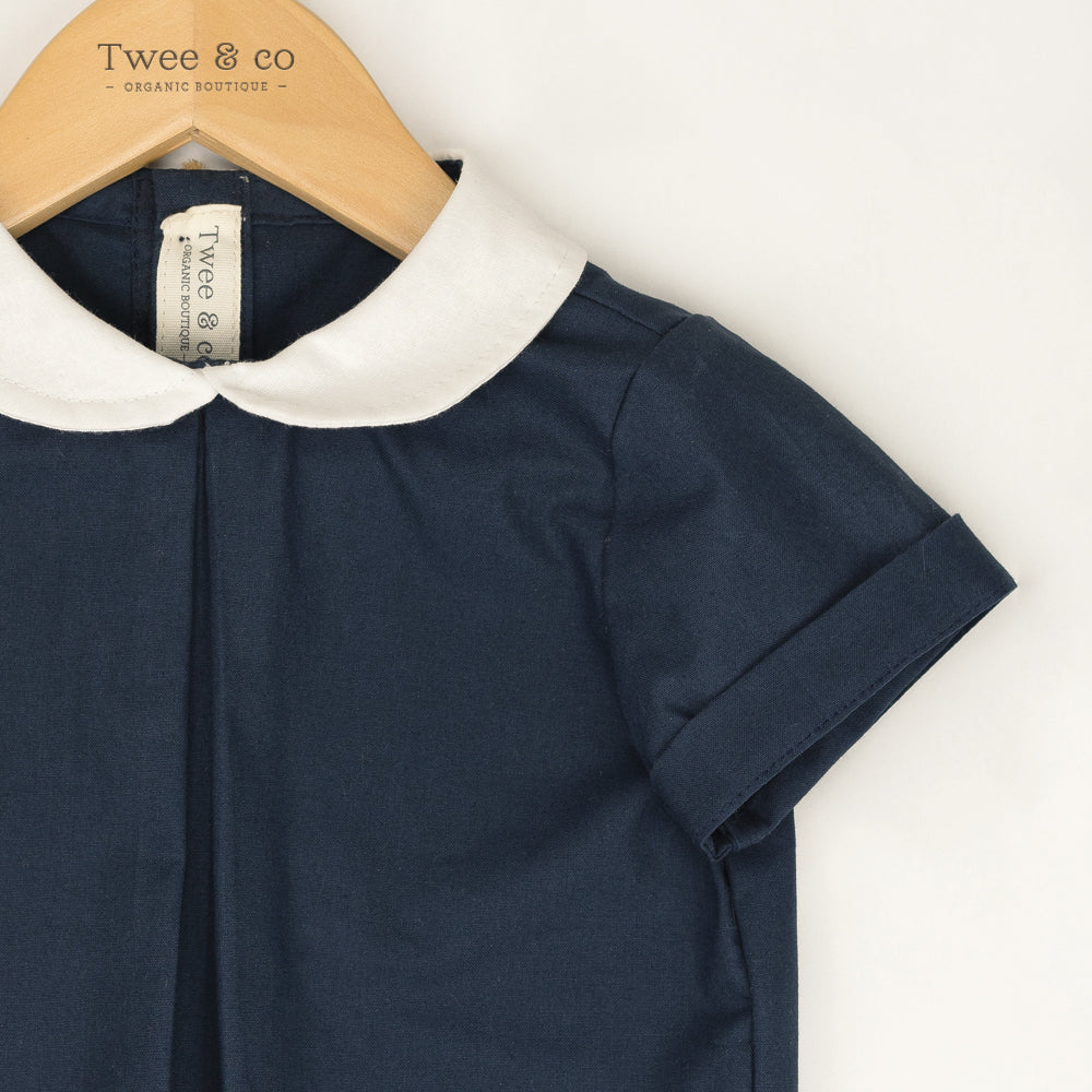 Young boy wearing Little Noah, organic cotton navy shirt with white Peter Pan collar — by Twee & Co 