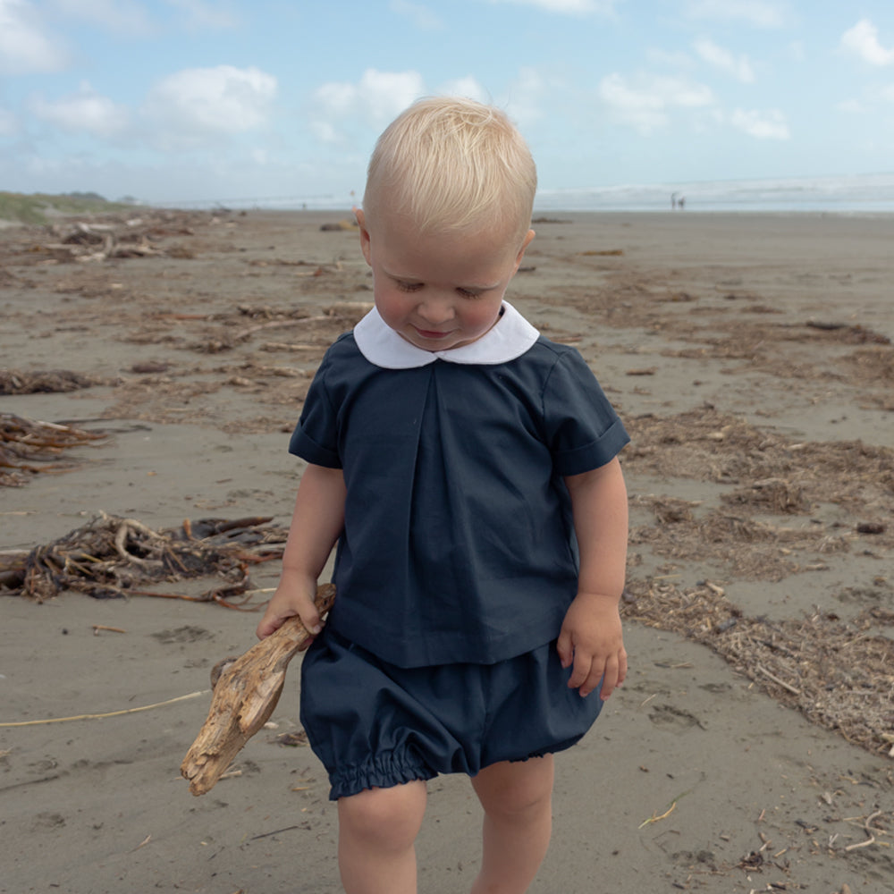 Toddler wearing Little Noah, organic cotton navy shirt with white Peter Pan collar — by Twee & Co 