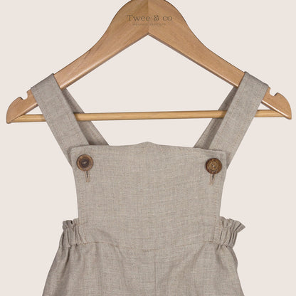 Winnie Romper by Twee & co Organic Boutique is made from organic linen and features non-toxic wooden buttons. Made in New Zealand NZ  a close up shot